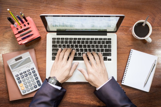 top-view-of-business-man-hands-working-on-laptop-or-tablet-pc-on-wooden-desk_1423-278.jpg